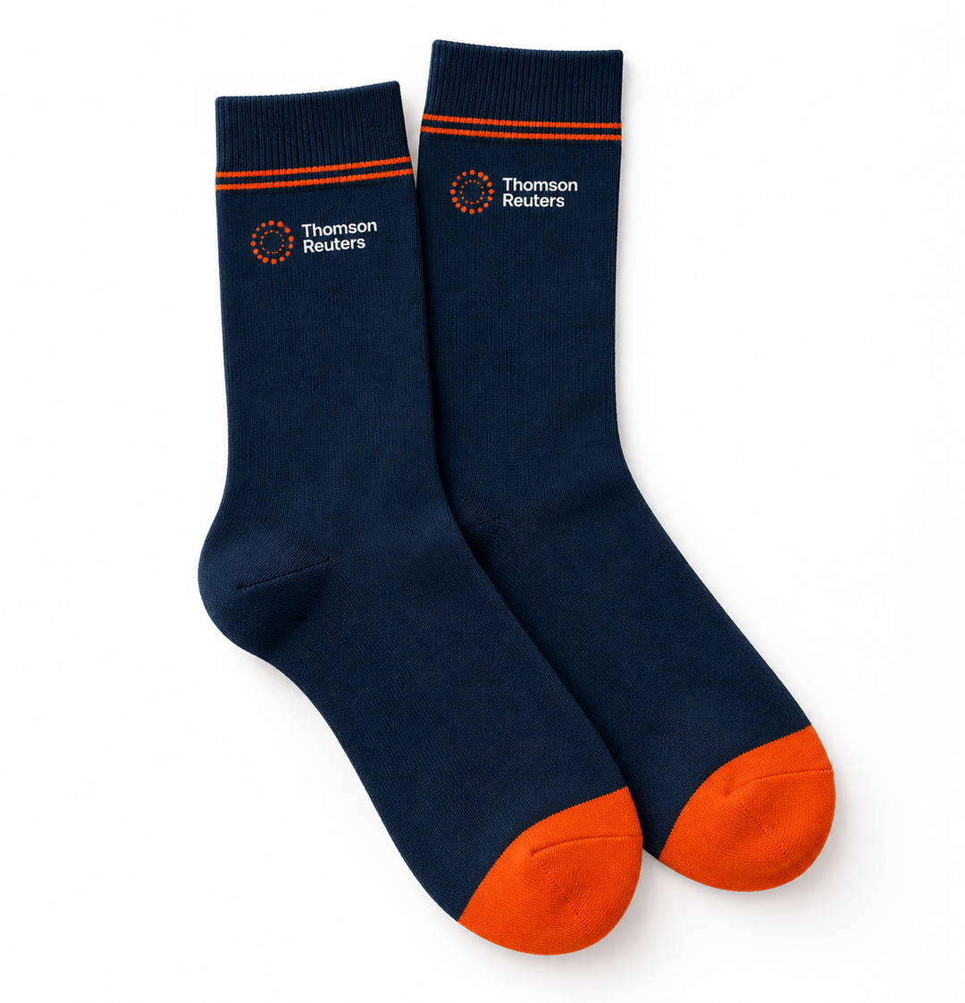 A pair of navy blue crew socks with bright orange toes and heels, featuring the Thomson Reuters logo printed in white and orange on the upper calf, set against a plain white background.