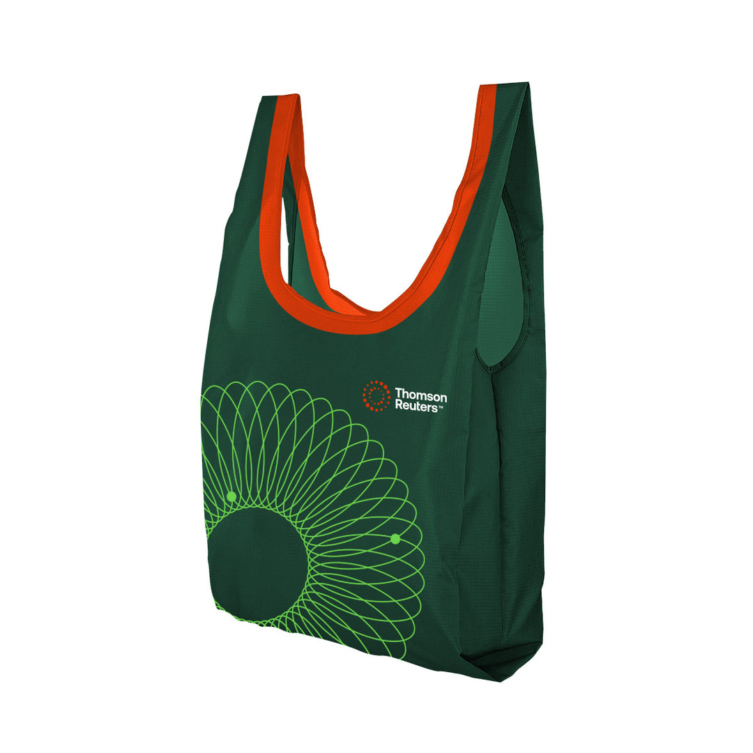 A dark green reusable shopping bag with bright orange handles and a green geometric sunburst graphic on the front, featuring the Thomson Reuters logo.