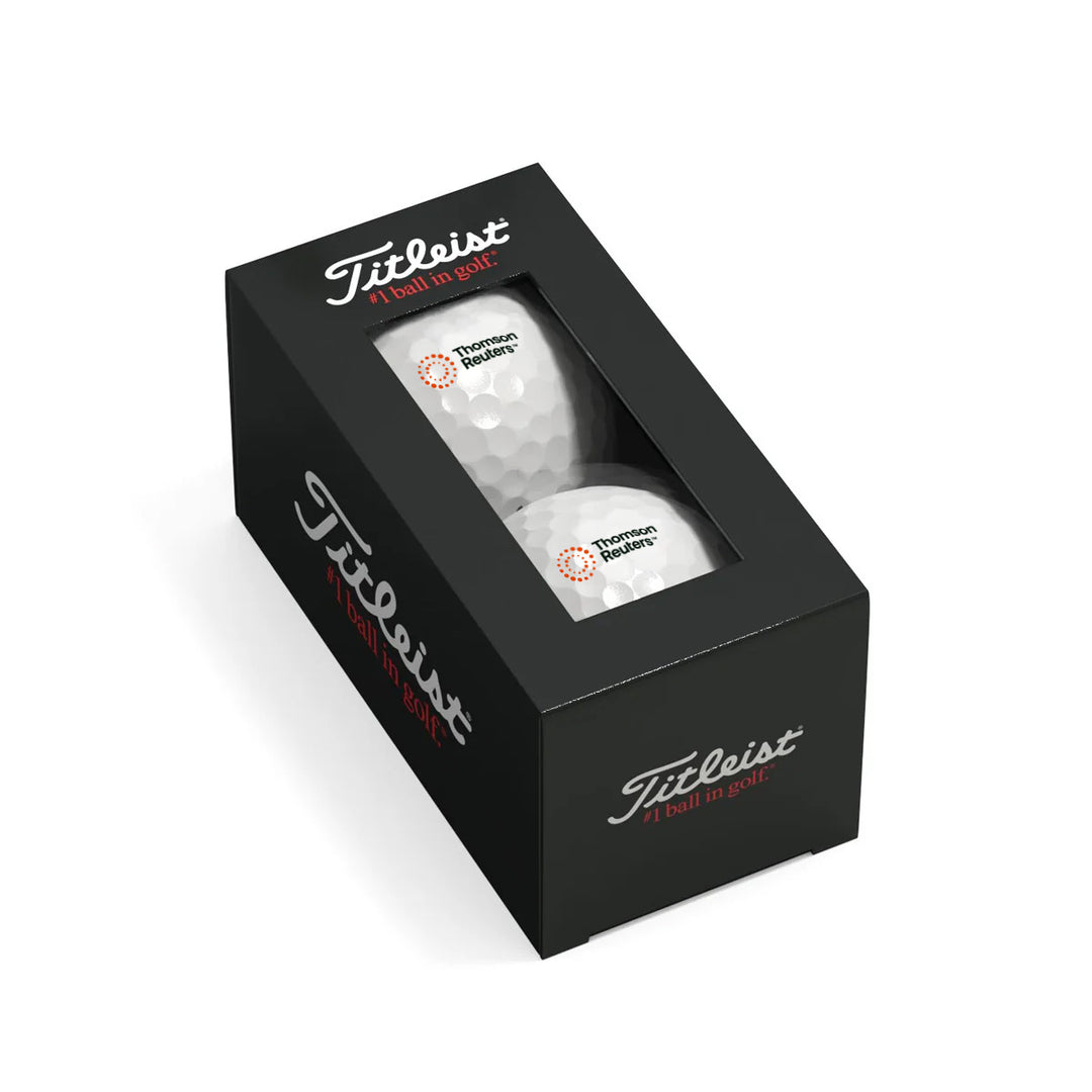Two white Titleist golf balls inside a black presentation box with a clear window, shown on a white background.